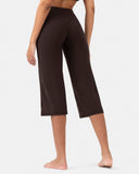 Rear view of a woman wearing high-waisted chocolate brown cropped yoga pants.