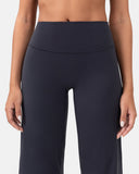 Woman wearing high-waisted, navy blue flared yoga pants for activewear.