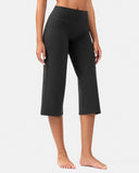 Woman wearing high-waisted black cropped yoga pants for workout or activewear.