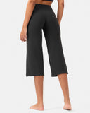 Woman wearing black high-waisted cropped yoga pants with a wide leg fit.