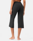 Rear view of a woman wearing high-waisted black cropped yoga pants.